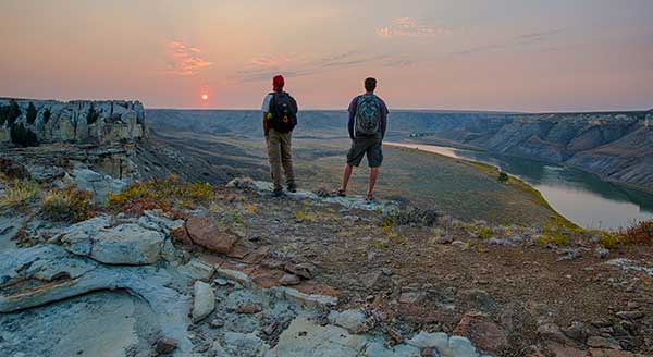 Two people look out over the Upper Missouri Breaks NM. - CC License - Bob Wick