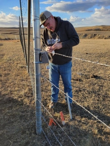 Larry Sickerson is working to place a game camera along Mt Highway 200 Photo taken by MWF staff Morgan Marks